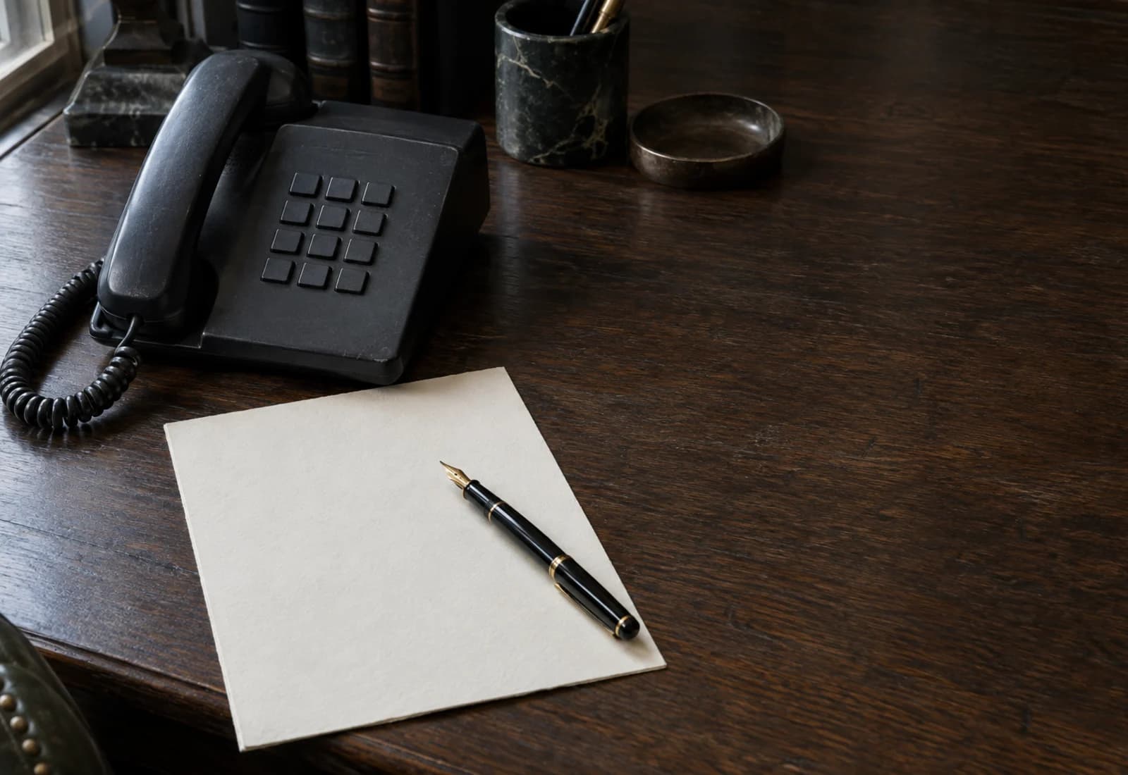 A desk telephone beside a closing file.